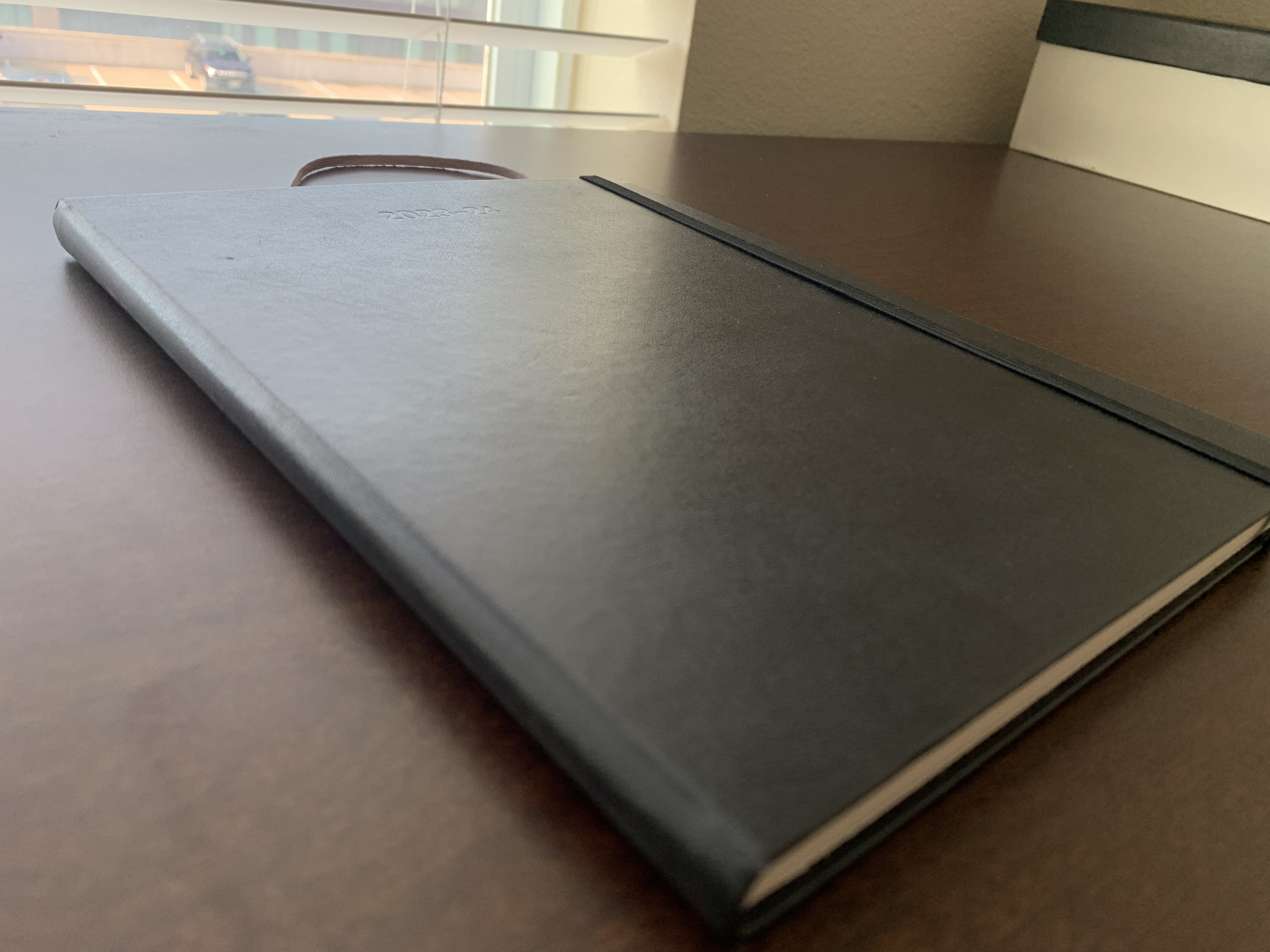 the large black classic planner, closed. the cover says 2023-24