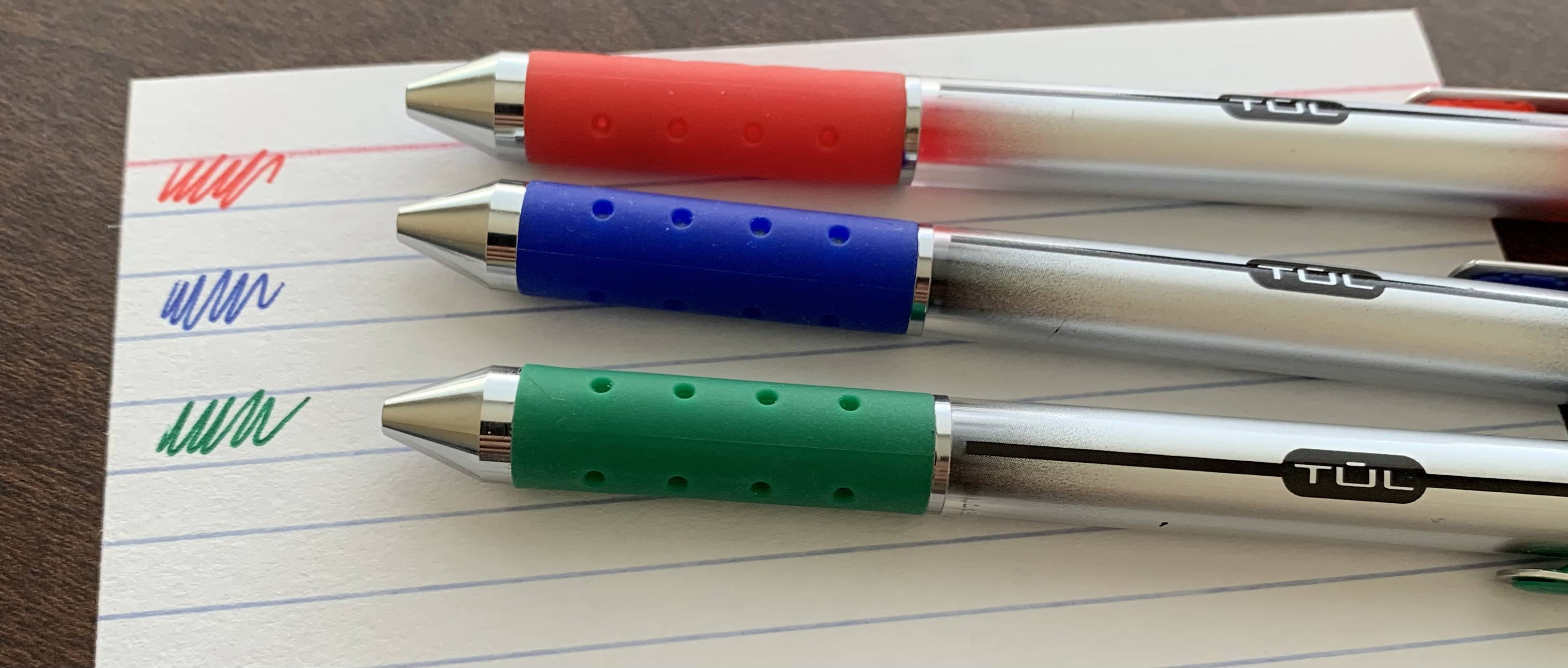 red, blue, and green tul gel pens resting on an index card