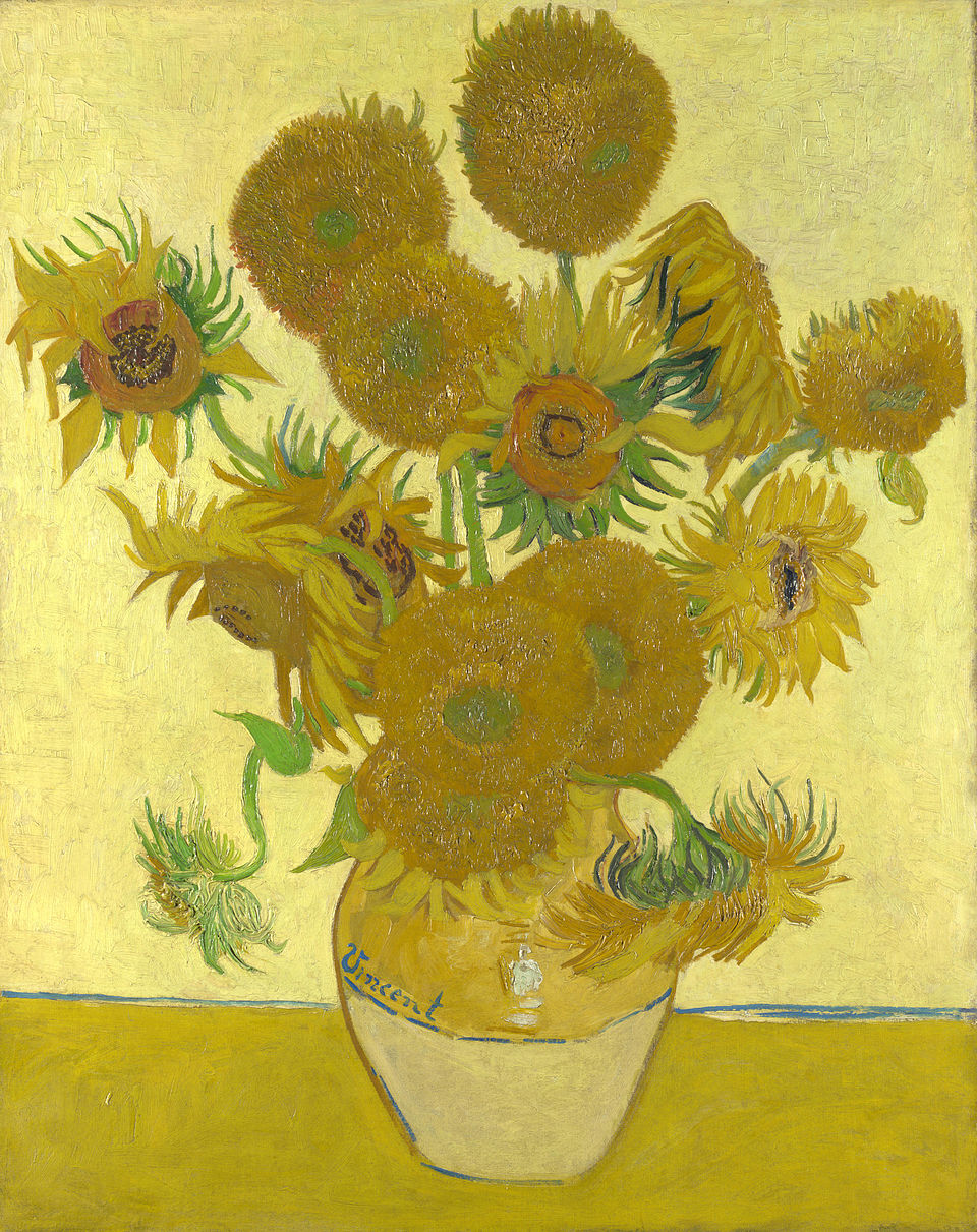 Van Gogh's sunflowers; the painting is very yellow. Many sunflowers are in a vase, they are facing every which way.